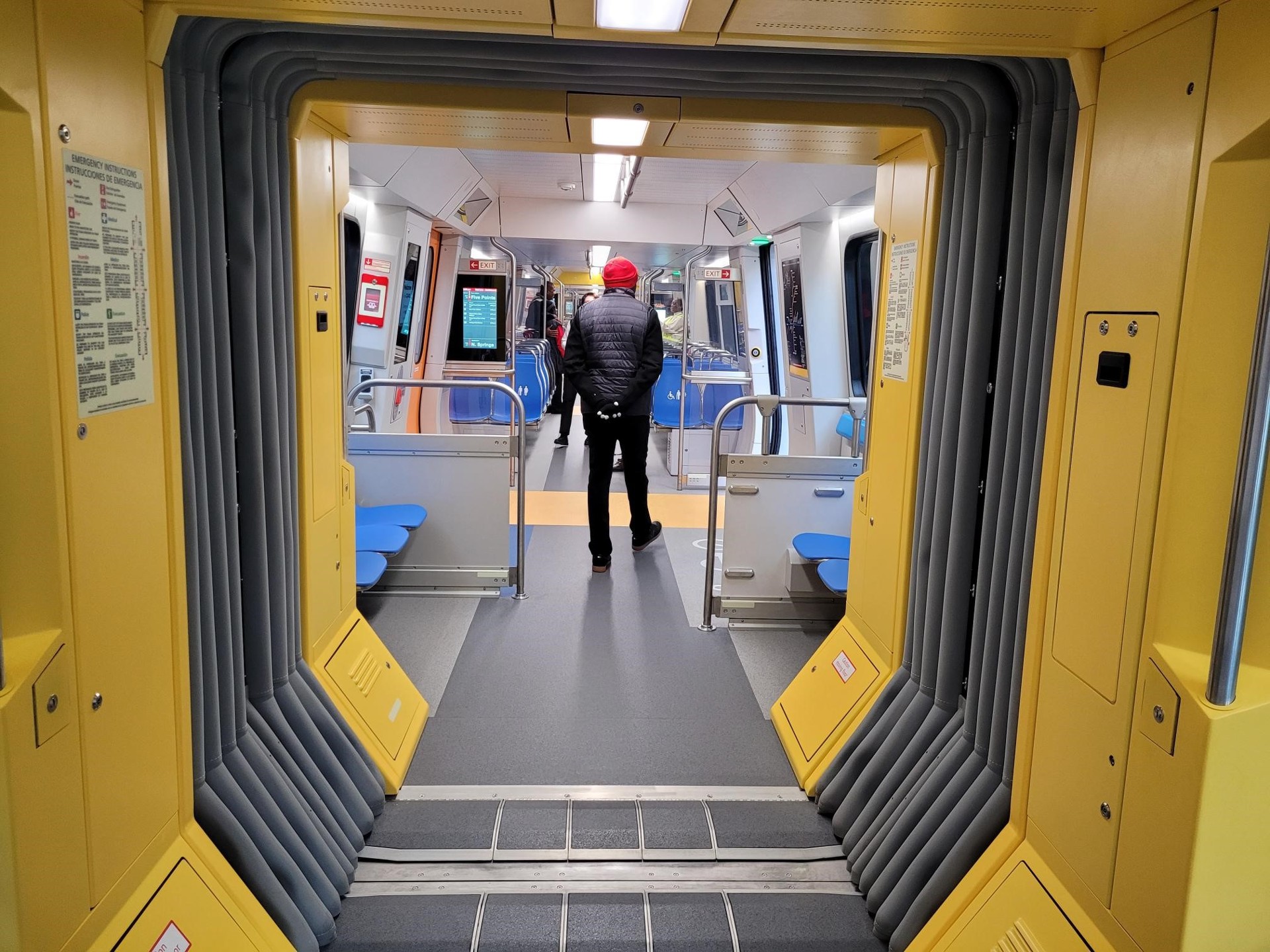 Look through the yellow doorway into the next car. The flexible gray sides let the train bend. Official photo: MARTA.