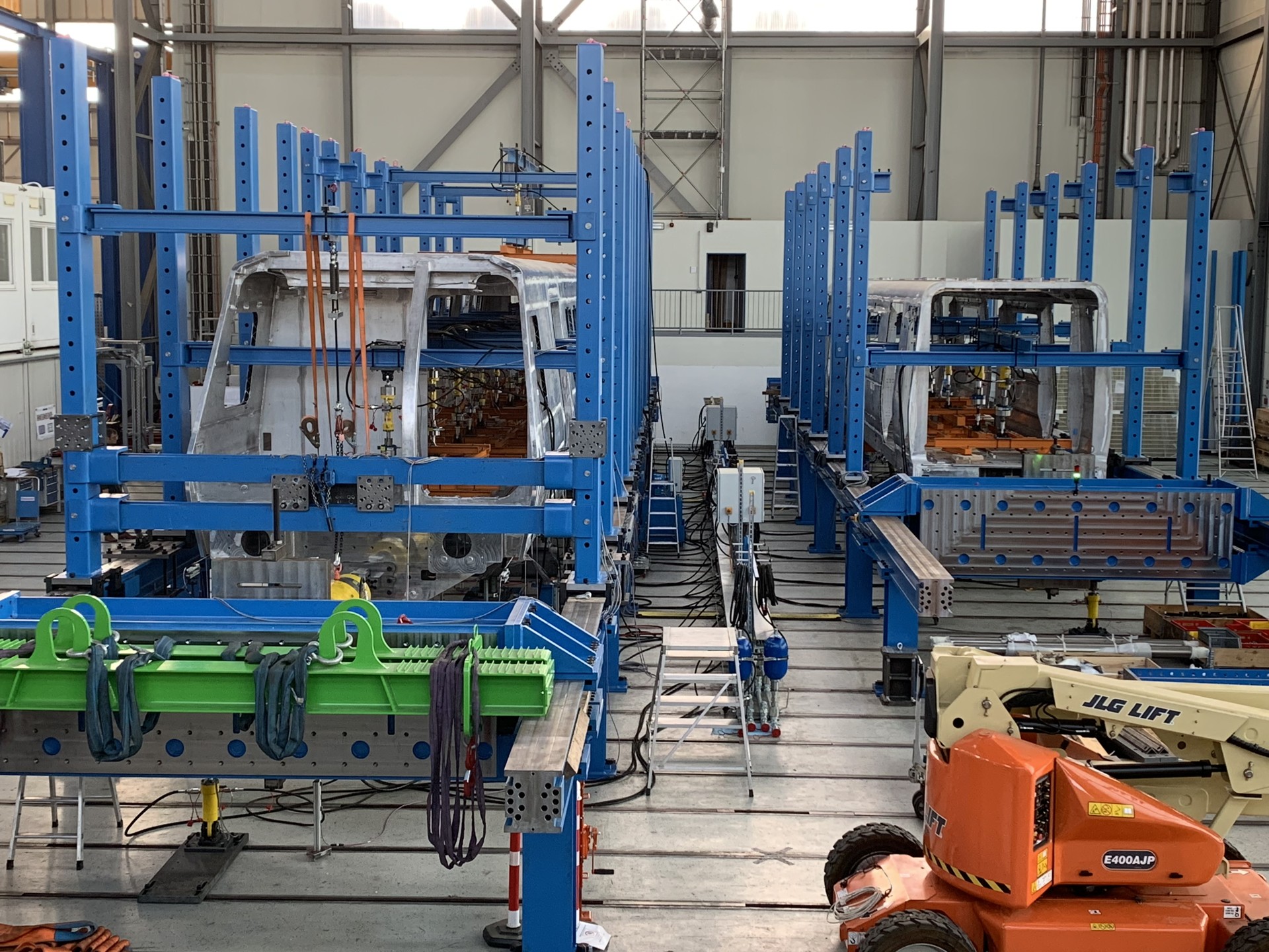 A new CQ400 is lifted in a factory for testing. Look at the equipment around the railcars. Official photo: MARTA.