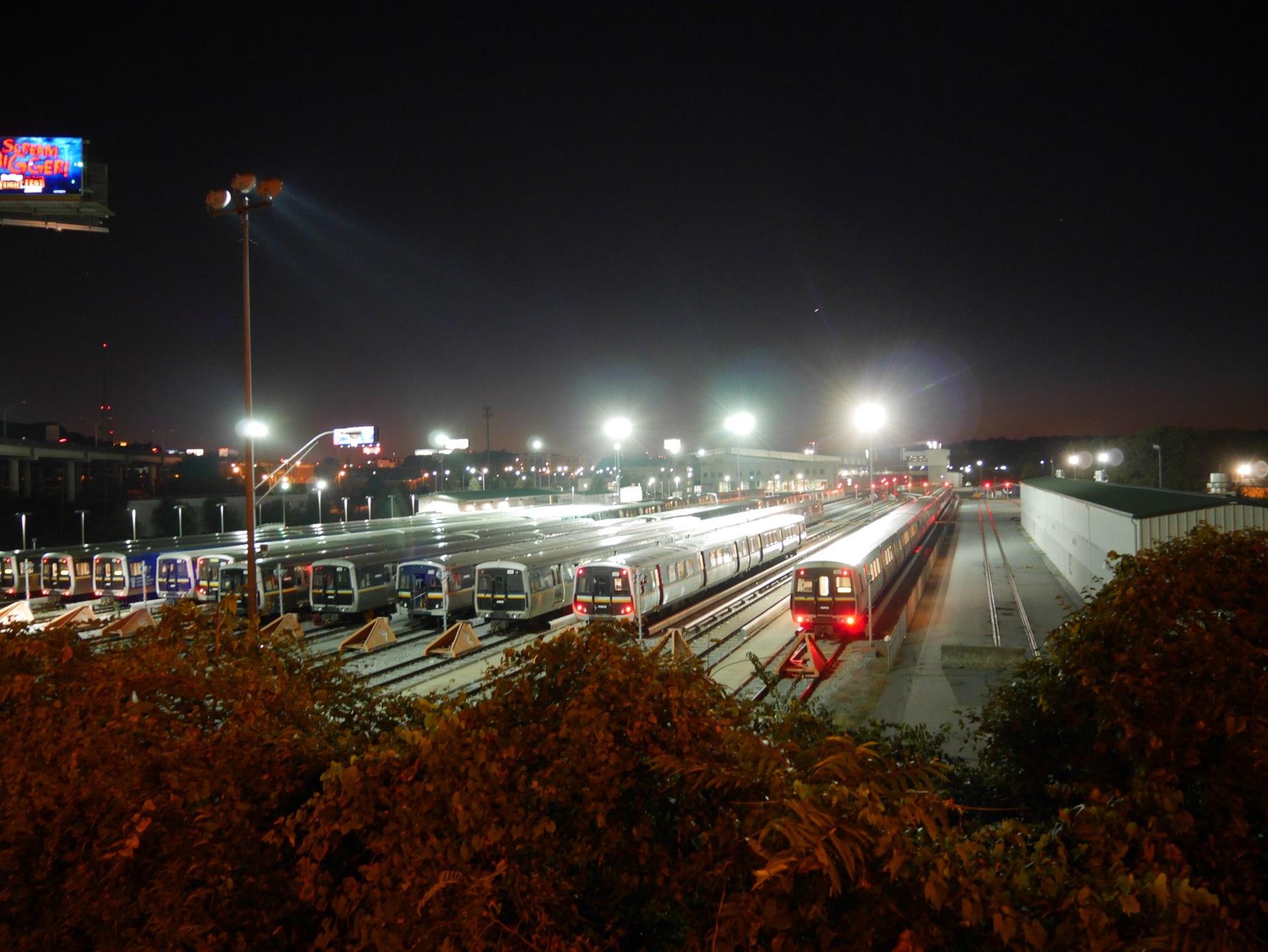 Rows of MARTA trains parked under bright lights at night