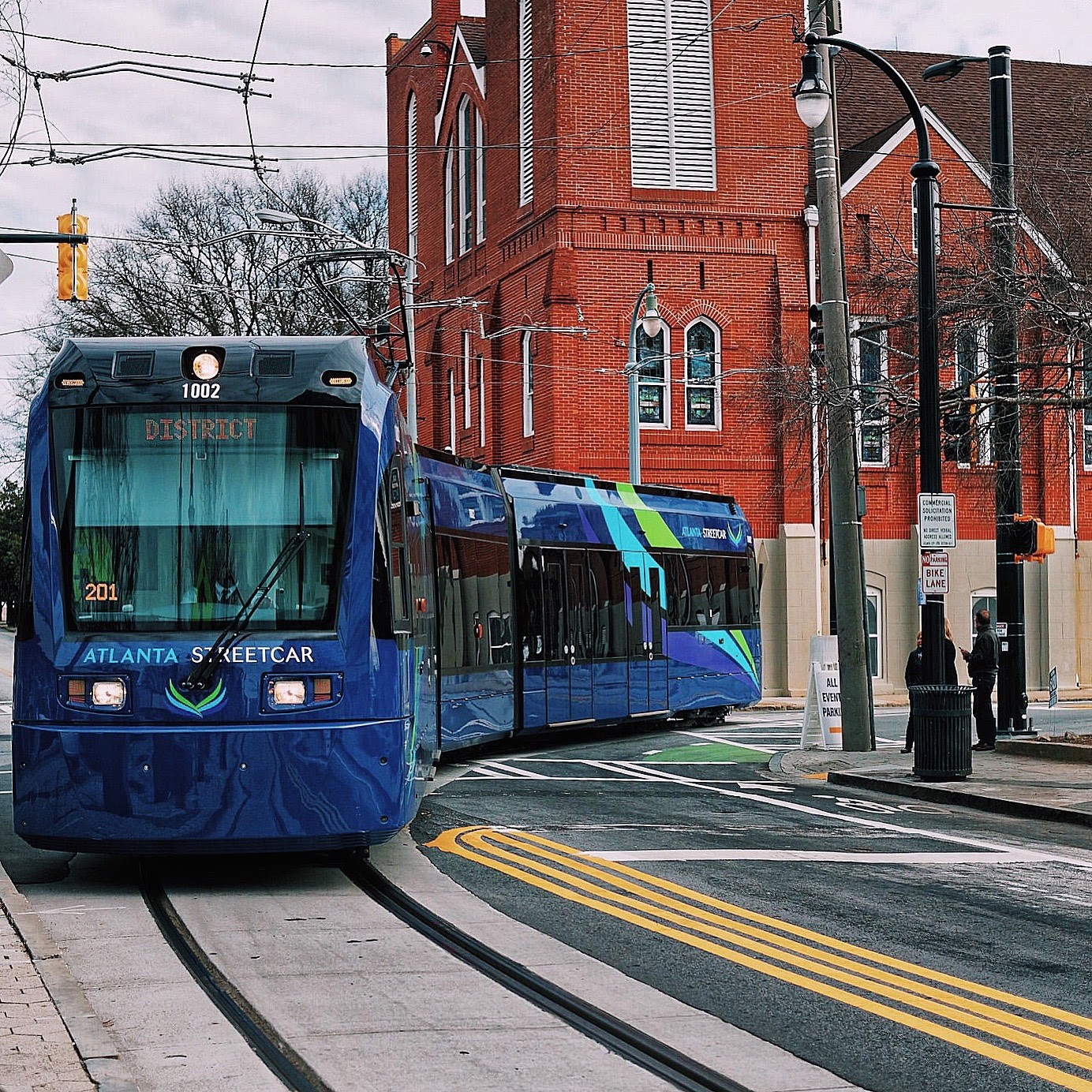 A blue Atlanta Streetcar on downtown tracks
